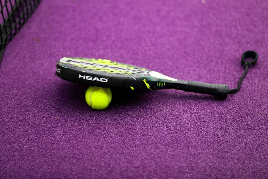 Padel court that has been newly resurfaced with a purple turf.