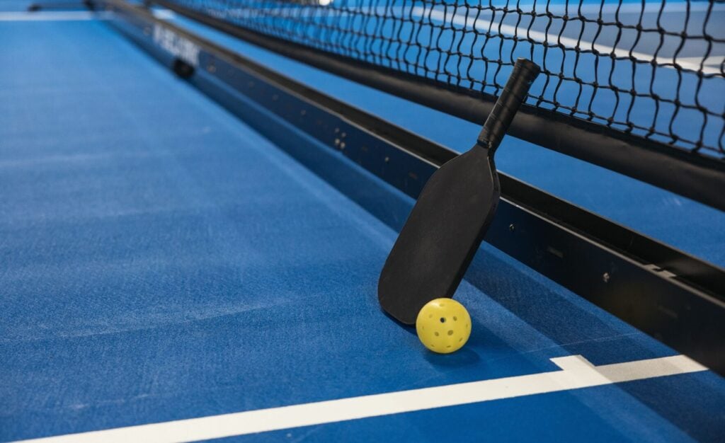Pickleball court thats been newly resurfaced with a blue turf.